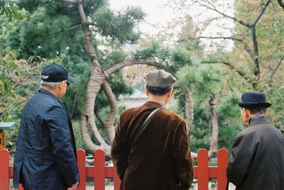 Rear view of men looking at trees