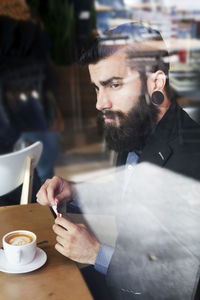 Young hipster businessman on break for a coffee