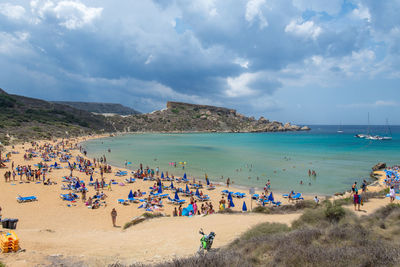 People on beach against sky