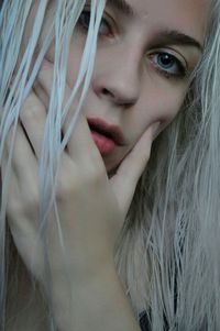 Close-up portrait of young woman with blond hair