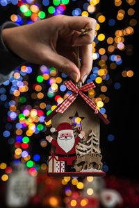 Midsection of person holding illuminated christmas lights