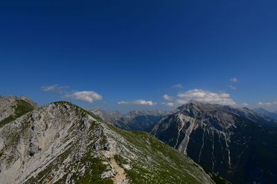 Scenic view of mountains against blue sky