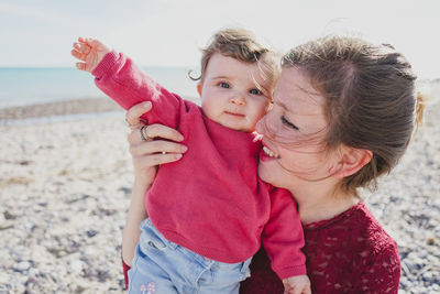 Portrait of mother and daughter on beach