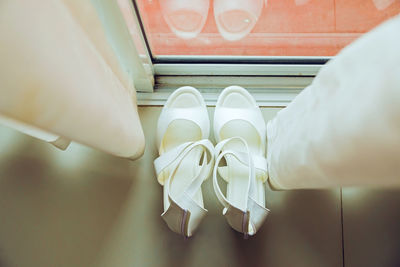 Directly above shot of high heels by window at home