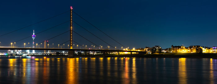 Illuminated bridge over river rhein in düsseldorf at night