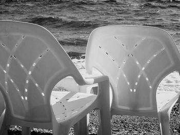 Close-up of empty chairs at beach