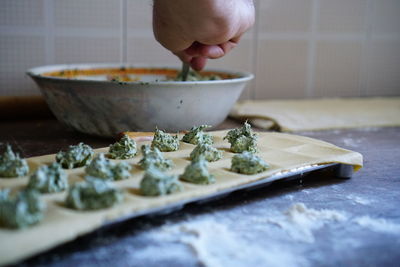 Close-up of person preparing food in kitchen