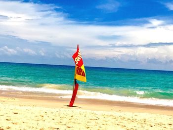 Lifeguard hut on beach against sky