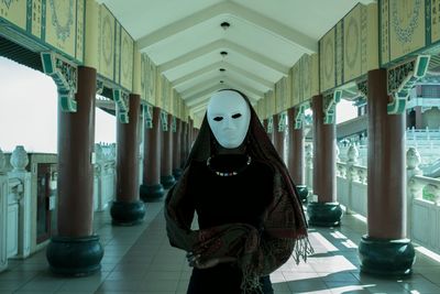 Portrait of man standing in corridor of building