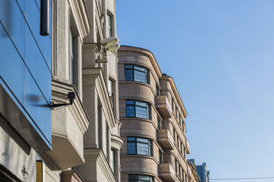 Low angle view of modern building against clear blue sky