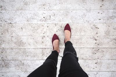 Low section of woman standing on tiled floor