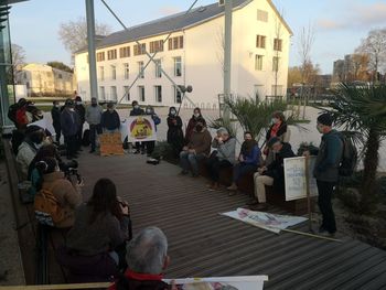 People on street against buildings in city