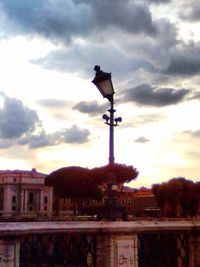 Built structure against cloudy sky at sunset