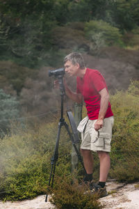 Man holding umbrella while standing on land