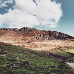 Scenic view of landscape against cloudy sky