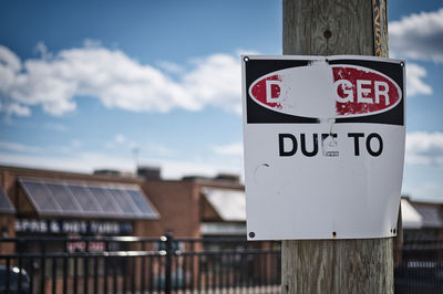 Close-up of information sign against building