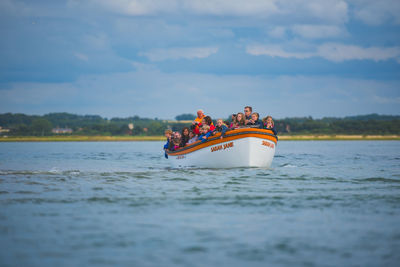 Boat sailing in sea against sky