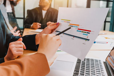 Midsection of business colleagues working at office