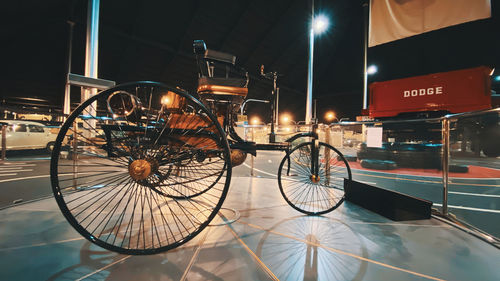 Bicycle parked on street in city at night