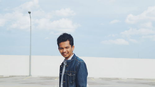 Portrait of smiling man standing outdoors