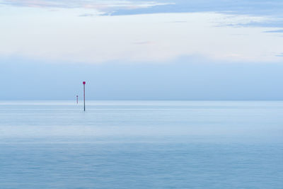 Marine warning sign. cloudy blue minimalist seascape. deserted space with horizon line.