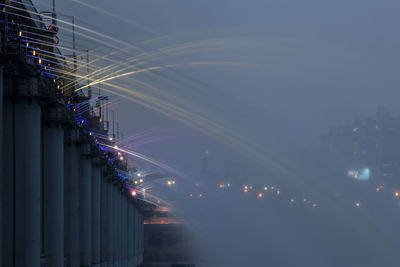 Low angle view of illuminated building against sky at night