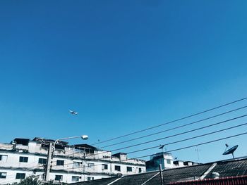 Low angle view of buildings against blue sky