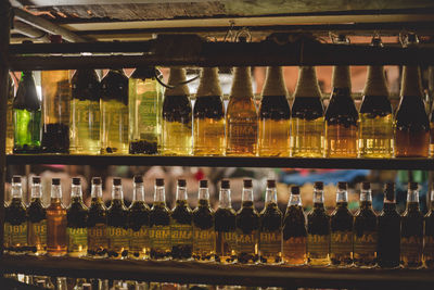 Row of bottles on display at bar