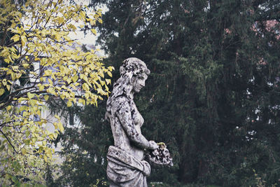 Statue against trees in park
