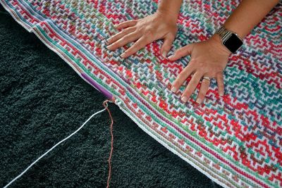 High angle view of woman hand on carpet