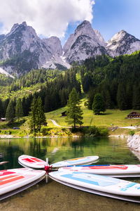 Scenic view of lake by mountains against sky