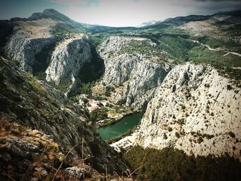 Scenic view of river amidst mountains against sky