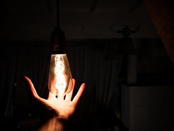 Person holding light bulb