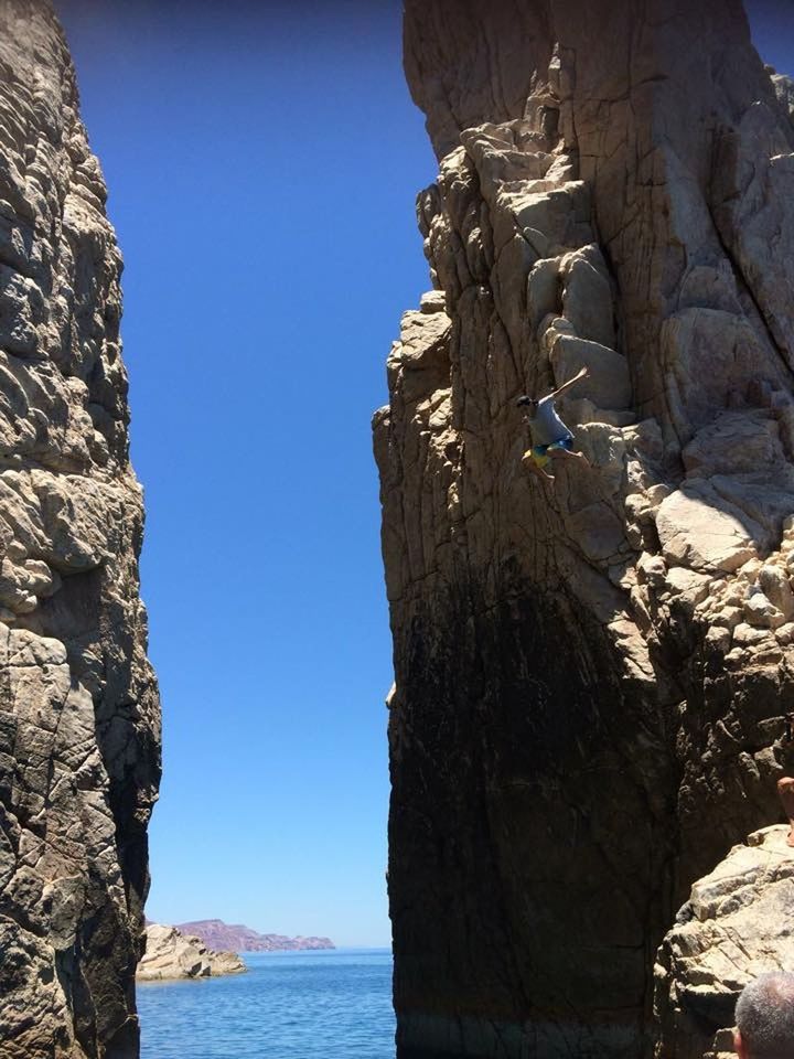 ROCK FORMATION BY SEA AGAINST CLEAR SKY