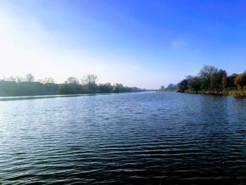Scenic view of lake against clear blue sky