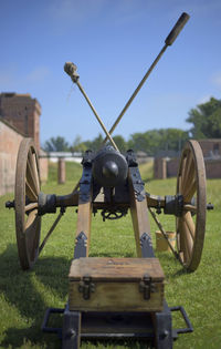 Close-up of machinery on field against clear sky