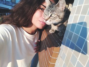 Portrait of young woman with cat