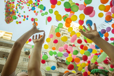 Low angle view of people playing balloons