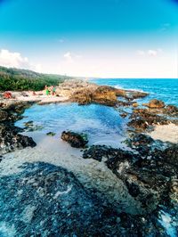 Scenic view of beach against blue sky