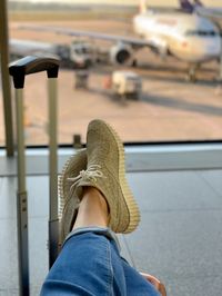 Low section of woman on suitcase in airport