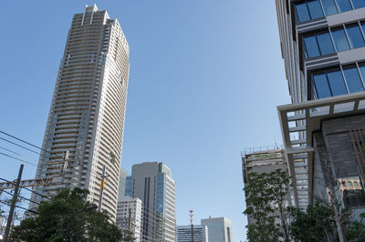 Low angle view of modern buildings against clear sky