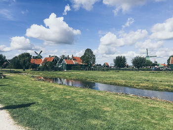 Scenic view of lake by building against sky