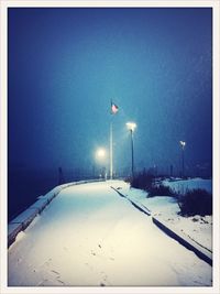 Snow covered road at night