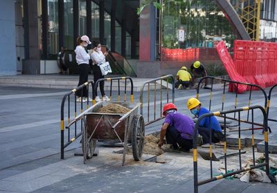 People sitting on chair in street