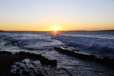 Scenic view of sea against sky during sunset