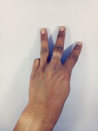 Close-up of human hand against white background