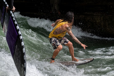 Full length of man splashing water