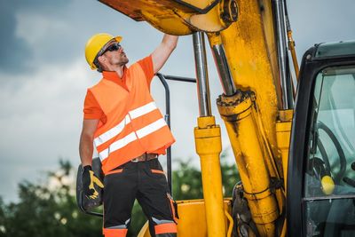 Worker standing by earth mover