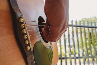 Cropped hand playing guitar