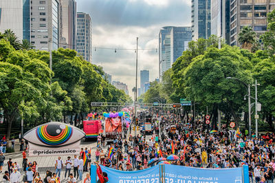 People on street against buildings in city